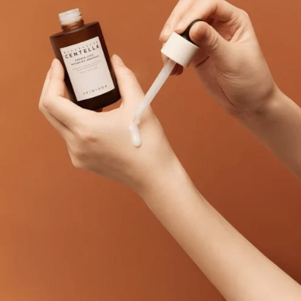 Skin TOGO SKIN1004 Madagascar Centella Probio-Cica Intensive Ampoule being applied to hand with a dropper