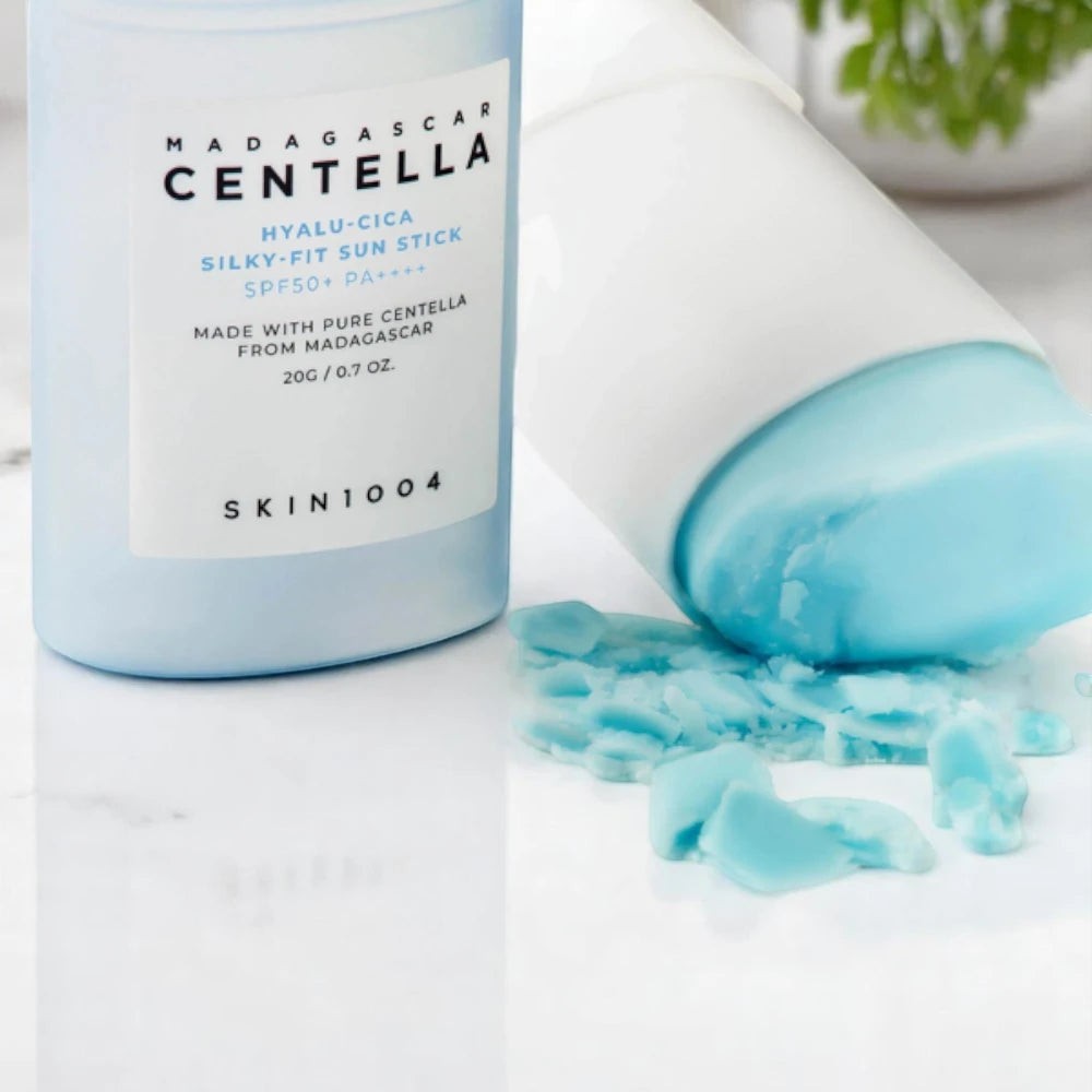Skin TOGO SKIN1004 Madagascar Centella Hyalu-Cica Silky-Fit Sun Stick with light blue balm texture on white surface