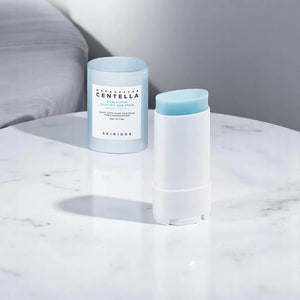 Skin TOGO SKIN1004 Madagascar Centella Hyalu-Cica Silky-Fit Sun Stick in a white and light blue compact container.