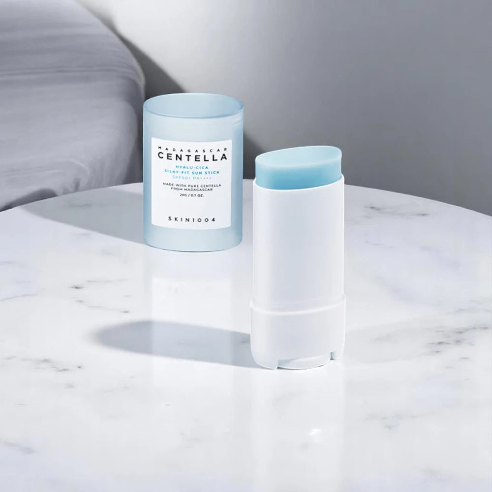 Skin TOGO SKIN1004 Madagascar Centella Hyalu-Cica Silky-Fit Sun Stick in a white and light blue compact container.