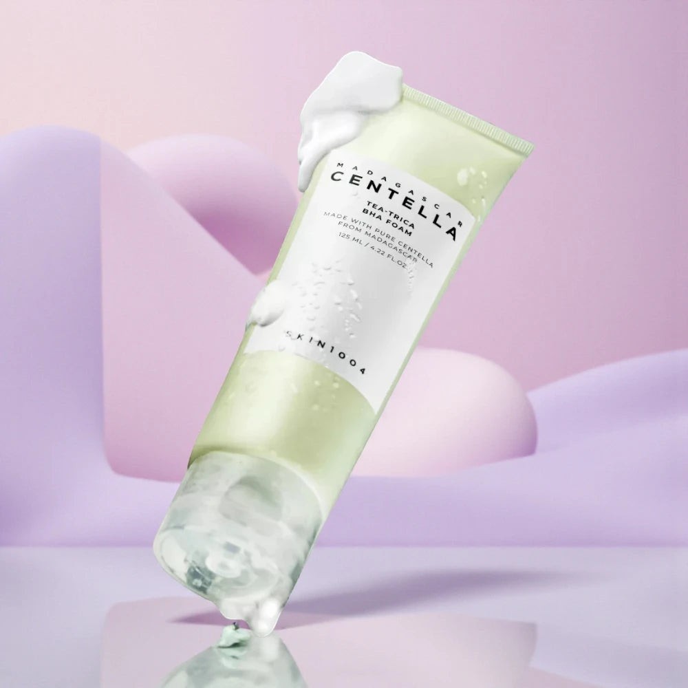 Skin TOGO SKIN1004 Madagascar Centella Tea-Trica BHA foam cleanser in a light green tube with creamy white foam.