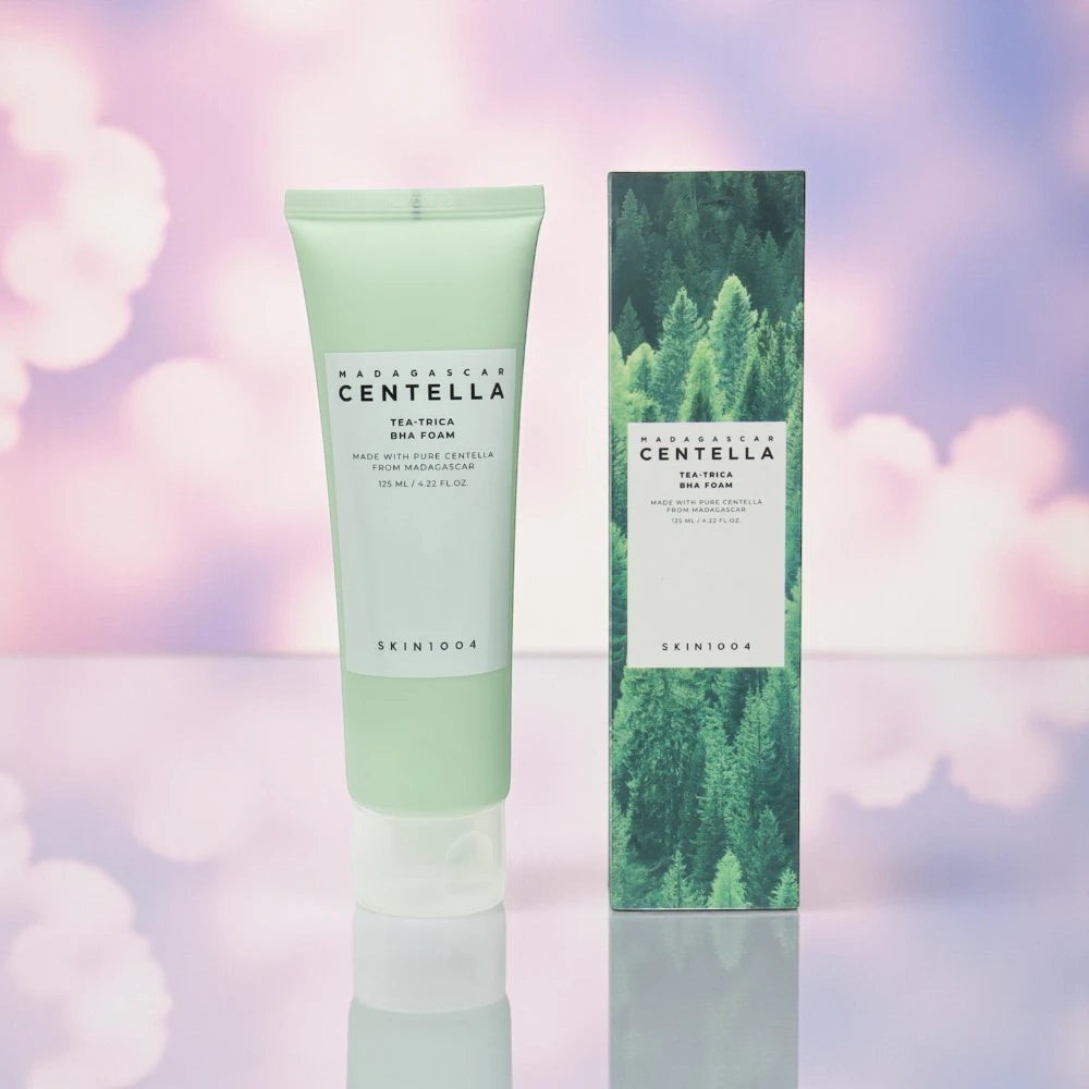Skin TOGO SKIN1004 Madagascar Centella Tea-Trica BHA Foam cleanser tube and box on a soft pink background.