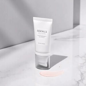 Skin TOGO SKIN1004 Madagascar Centella Tone Brightening Tone-Up Sunscreen SPF50+ tube with a drop of cream.