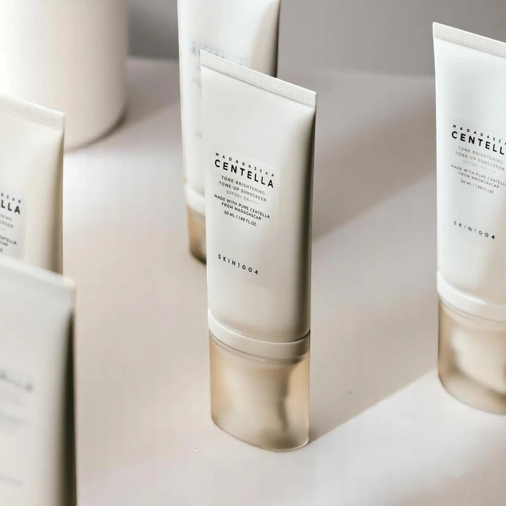 Skin TOGO SKIN1004 Madagascar Centella Tone Brightening Tone-Up Sunscreen SPF50+ in a white tube on a neutral surface.