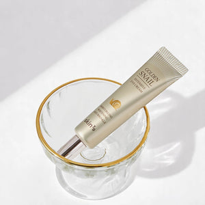 Skin TOGO Skin79 Golden Snail Intensive Eye Cream in a gold-rimmed glass bowl for anti-wrinkle skin care.
