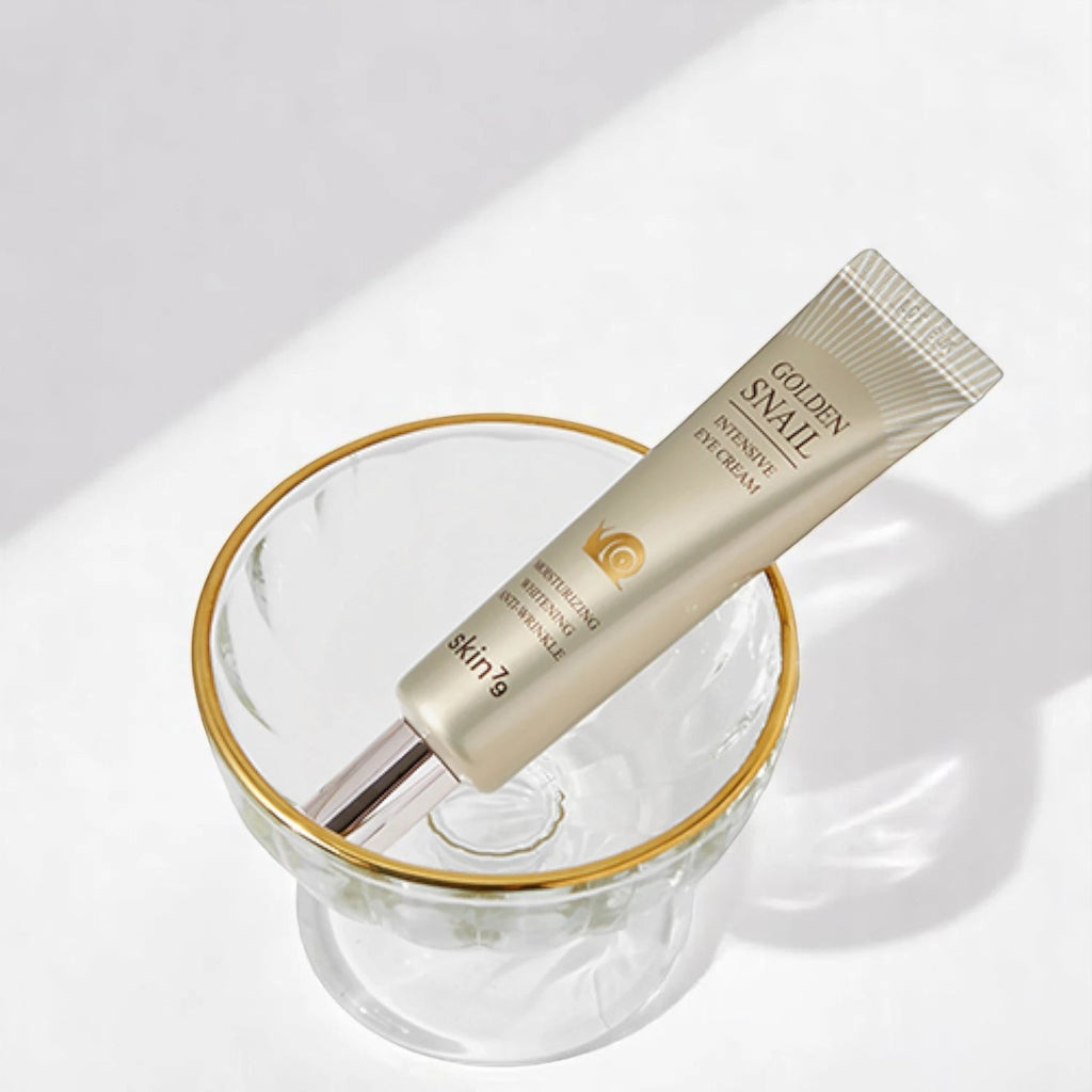 Skin TOGO Skin79 Golden Snail Intensive Eye Cream in a gold-rimmed glass bowl for anti-wrinkle skin care.