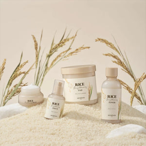 Skin TOGO SKINFOOD Rice Brightening skincare collection including cream, serum, pads, and toner on a bed of rice.