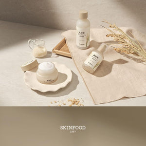 Skin TOGO SKINFOOD Rice Brightening skincare set featuring toner, serum, and cream with rice extracts on a cloth.