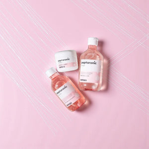 Skin TOGO SNP Prep Peptaronic skincare set including serum, toner, and cream in pink bottles on a pink background.
