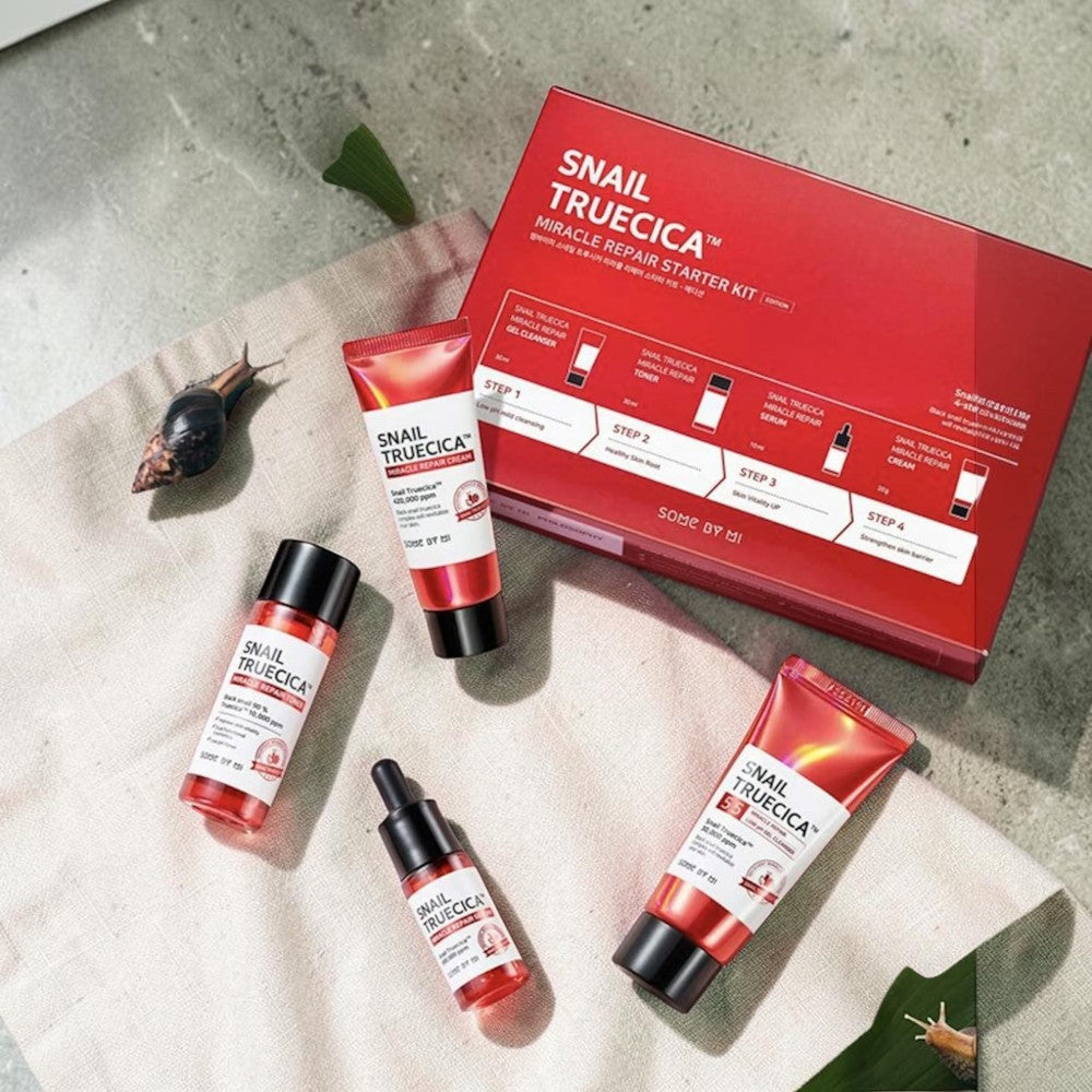 Skin TOGO Some By Mi Snail Truecica Miracle Repair Starter Kit with cleanser, toner, serum, and cream on pink background