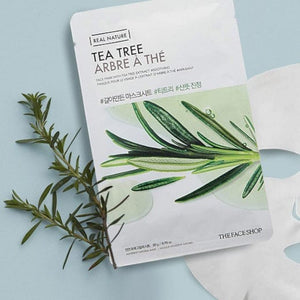 Skin TOGO The Face Shop Real Nature Tea Tree sheet mask packaging with fresh tea tree leaves on a light blue background