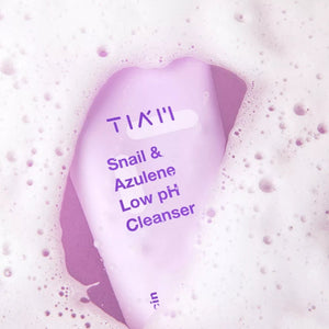 Skin TOGO TIAM Snail & Azulene Low pH Cleanser bottle surrounded by soft white cleansing foam