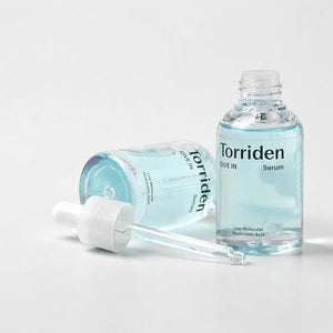 Skin TOGO Torriden DIVE-IN hyaluronic acid serum in a clear glass bottle with a dropper on a white background.