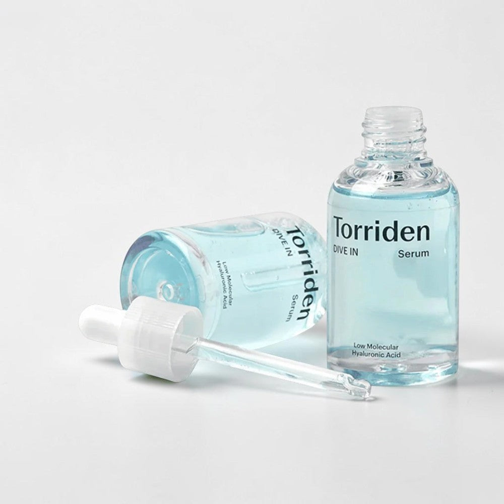 Skin TOGO Torriden DIVE-IN hyaluronic acid serum in a clear glass bottle with a dropper on a white background.