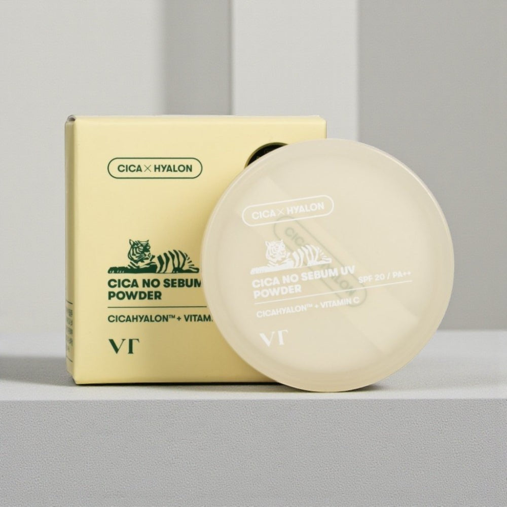 Skin TOGO VT Cosmetics Cica No-Sebum Mild Powder in a light yellow container with matching box on a neutral surface.