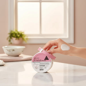 Skin TOGO VT Cosmetics Reedle Shot EX Collagen modelling mask container with a hand applying cream on a marble table.