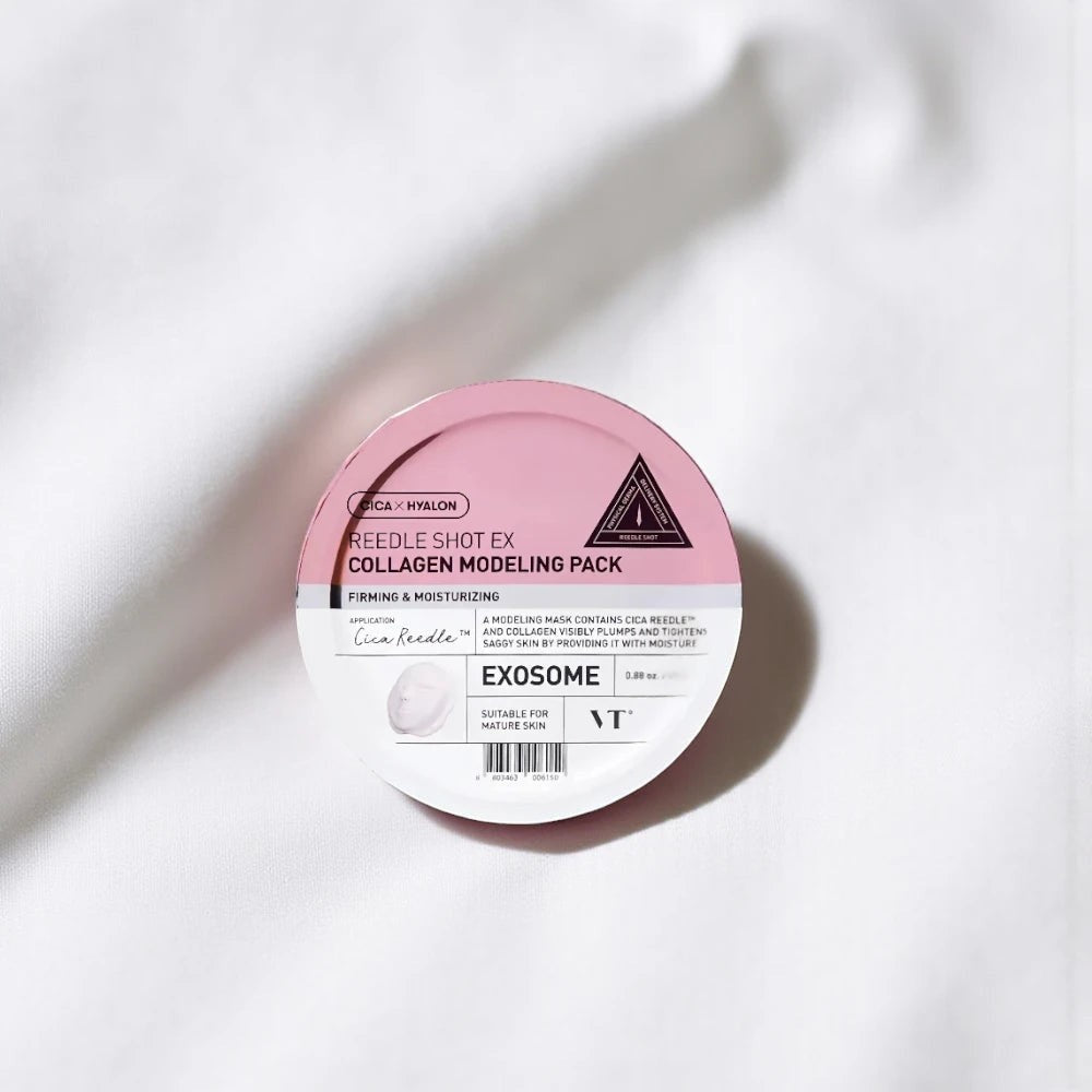 Skin TOGO VT Cosmetics Reedle Shot EX Collagen modelling pack in a round pink container on white fabric.