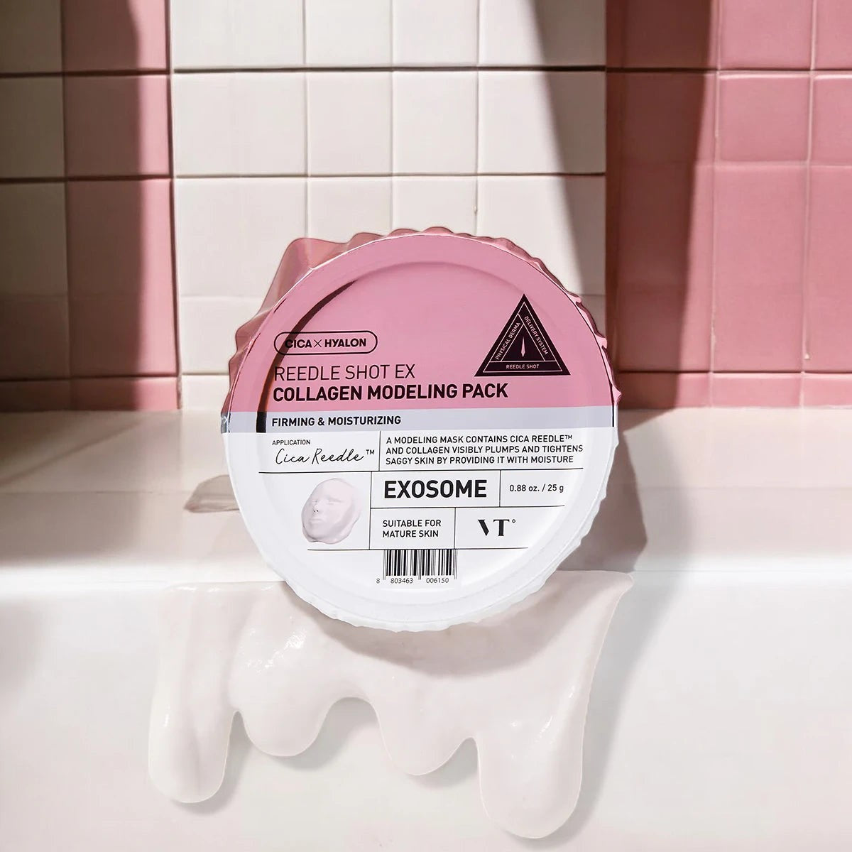 Skin TOGO VT Cosmetics Reedle Shot EX Collagen Modelling Pack in a pink container against a tiled bathroom wall.