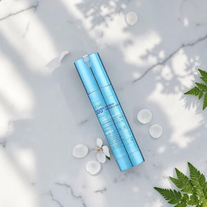 Skin TOGO VT Cosmetics Hydrop Reedle Shot 300hL hydrating serum in a metallic blue pump bottle on white fabric.