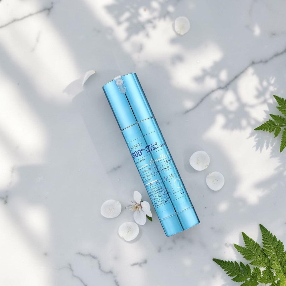 Skin TOGO VT Cosmetics Hydrop Reedle Shot 300hL hydrating serum in a metallic blue pump bottle on white fabric.