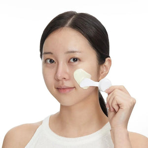 Skin TOGO model applying VT Cosmetics Reedle Shot EX Cica Modeling Pack with a white spatula to her cheek