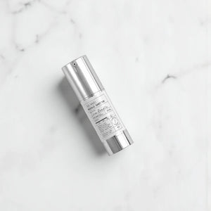 Skin TOGO VT Cosmetics Reedle Shot 700 microneedle essence bottle on a white marble surface
