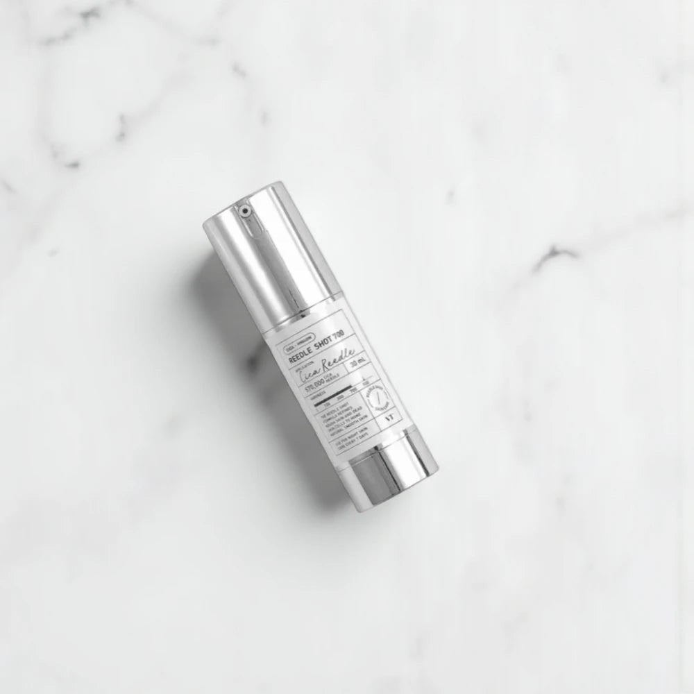 Skin TOGO VT Cosmetics Reedle Shot 700 microneedle essence bottle on a white marble surface