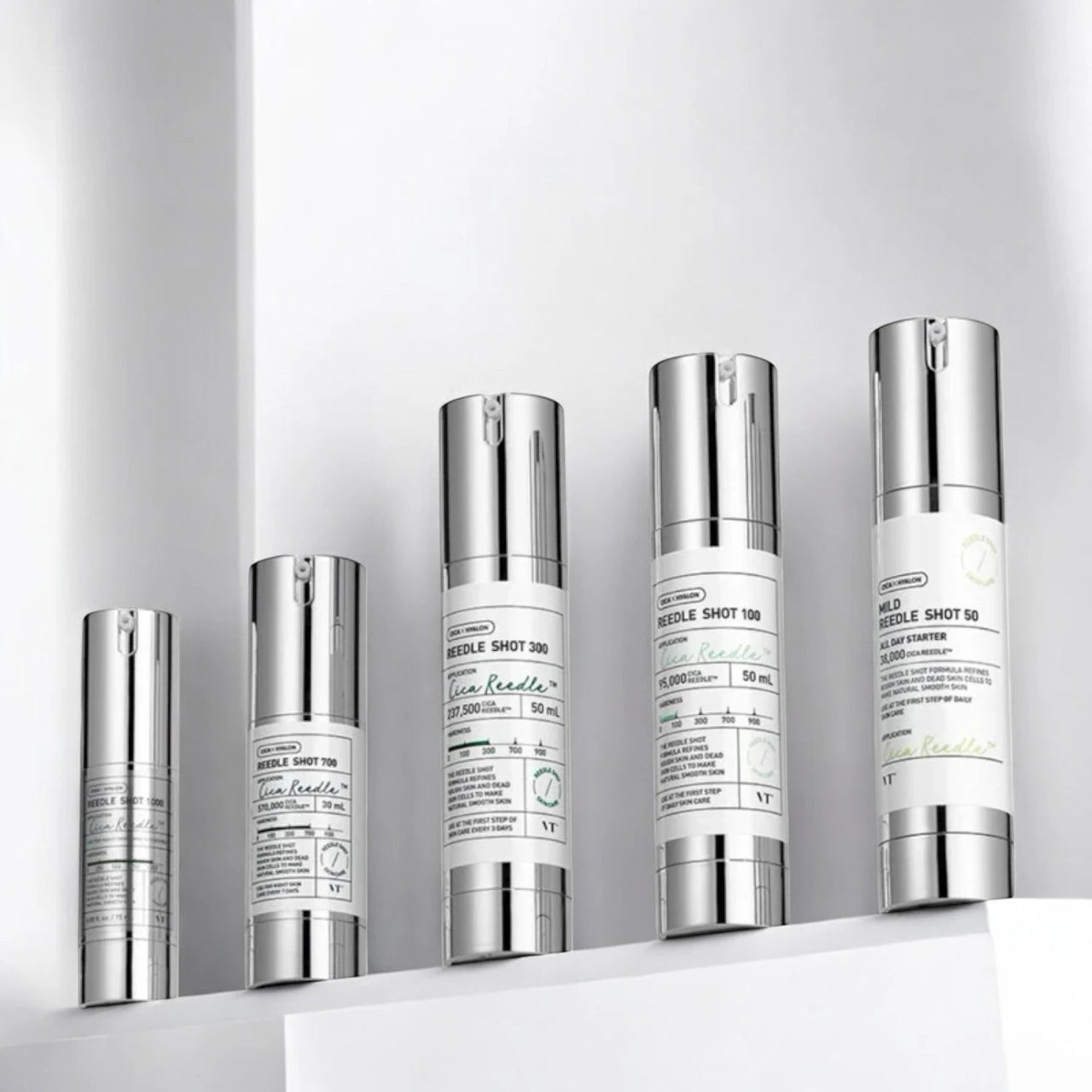 Skin TOGO VT Cosmetics Reedle Shot essence collection in silver pump bottles on a white shelf for skincare routine
