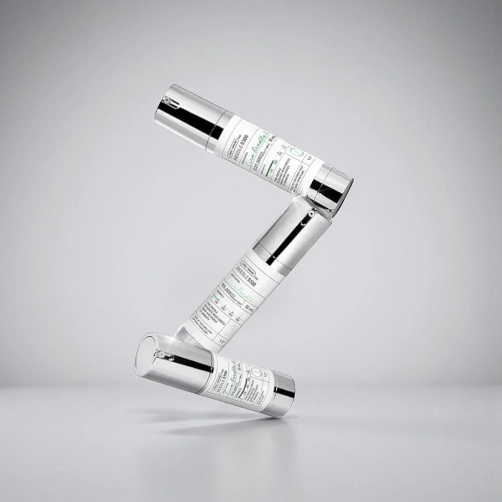 Skin TOGO VT Cosmetics Reedle Shot 100 essence bottles stacked in a Z-shape against a neutral studio background.